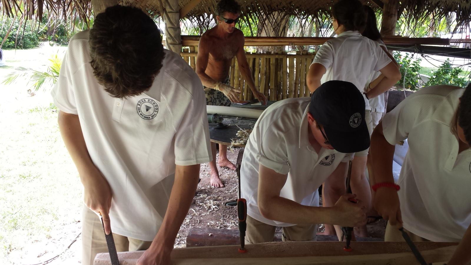 students learning traditional woodworking techniques